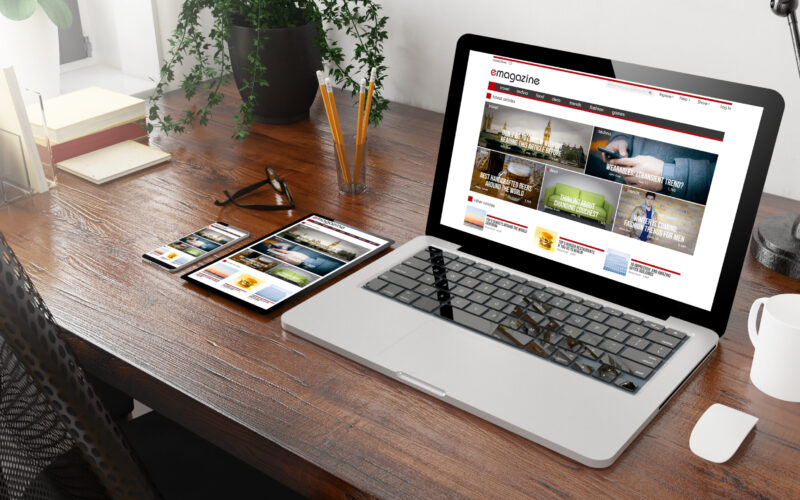 devices e-magazine on wooden desktop 3d rendering