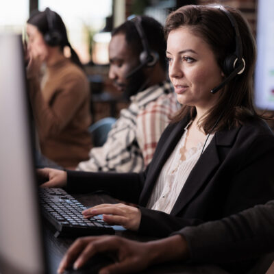Sales assistant being employed at customer care support job, working on telemarketing call center at helpdesk. Female receptionist with helpline service helping clients on remote communication.