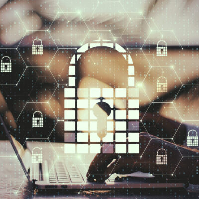 Side view of hands using laptop and smartphone with creative glowing digital padlock interface on blurry background with icons. Safety and protection concept. Multiexposure